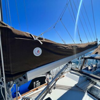 Brown lazy jack cover made by precision sails, installed on boat.