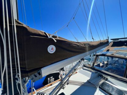 Brown lazy jack cover made by precision sails, installed on boat.